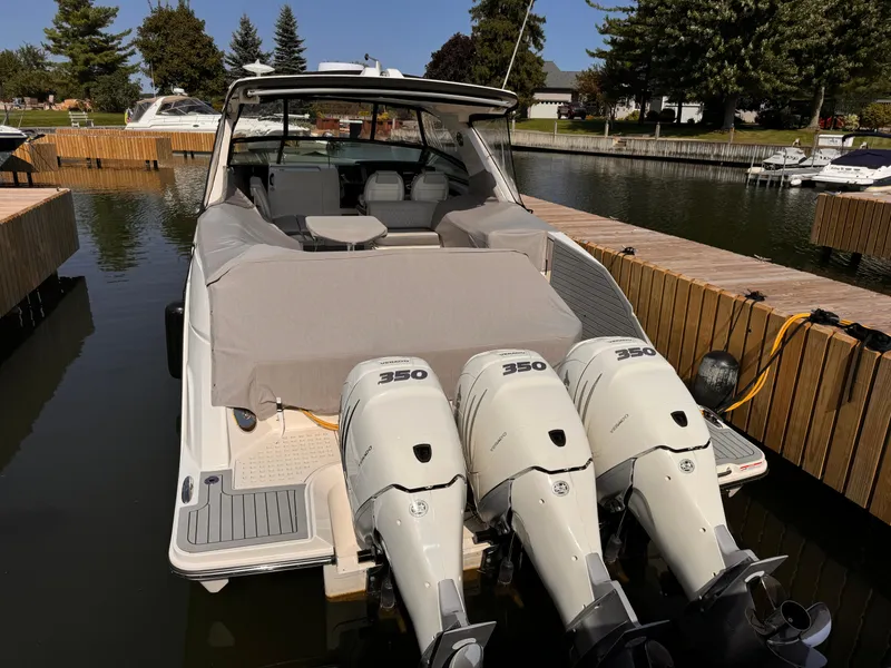 Slide: The Image of 2021 Sea Ray SLX 400 Outboard with triple engines docked at marina. - 31