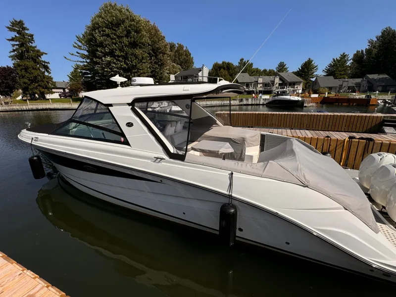 Slide: The Image of 2021 Sea Ray SLX 400 Outboard docked in a serene marina setting. - 33