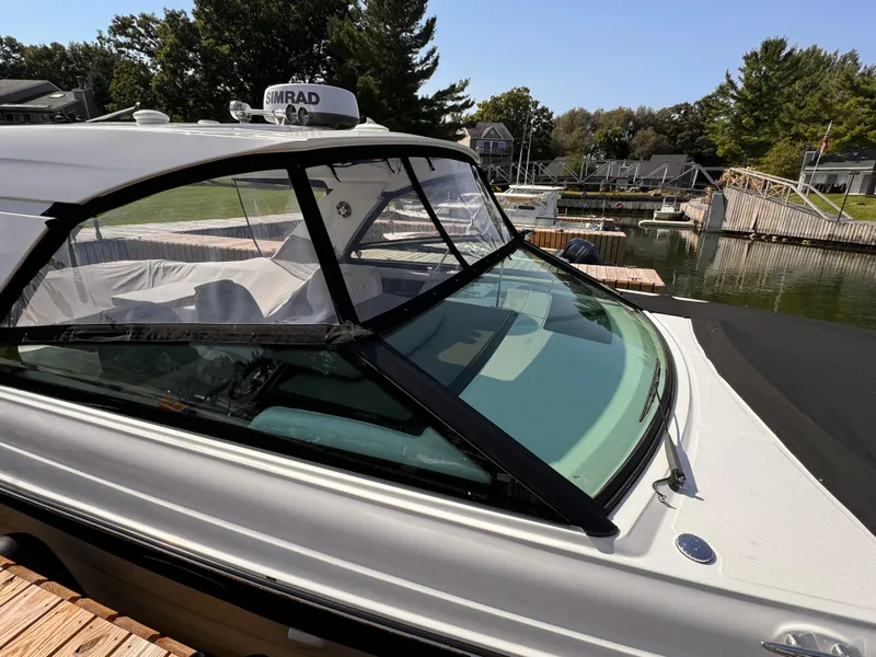 Slide: The Image of 2021 Sea Ray SLX 400 Outboard docked, showcasing sleek design and spacious interior. - 34