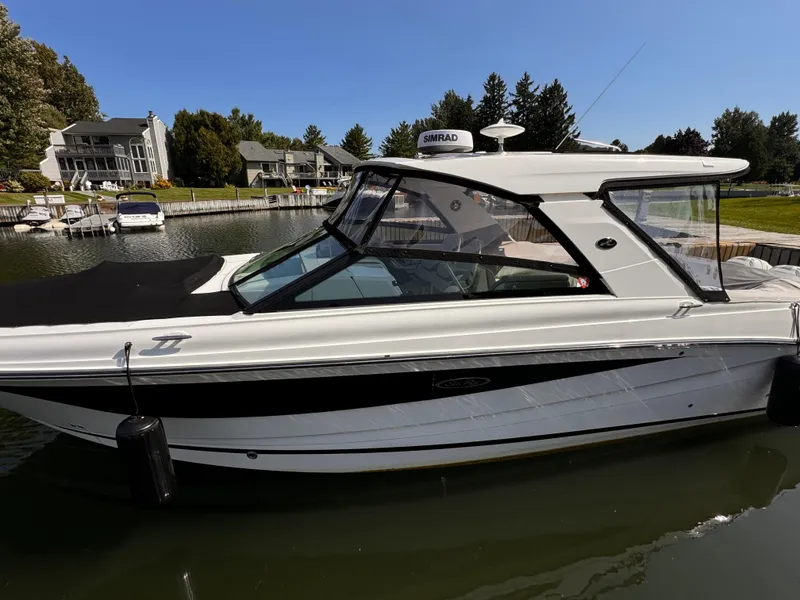 Slide: The Image of 2021 Sea Ray SLX 400 Outboard boat docked in a serene marina setting. - 36