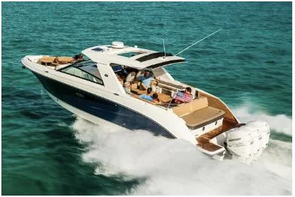 Slide: The Image of 2021 Sea Ray SLX 400 Outboard cruising on clear blue water. - 38