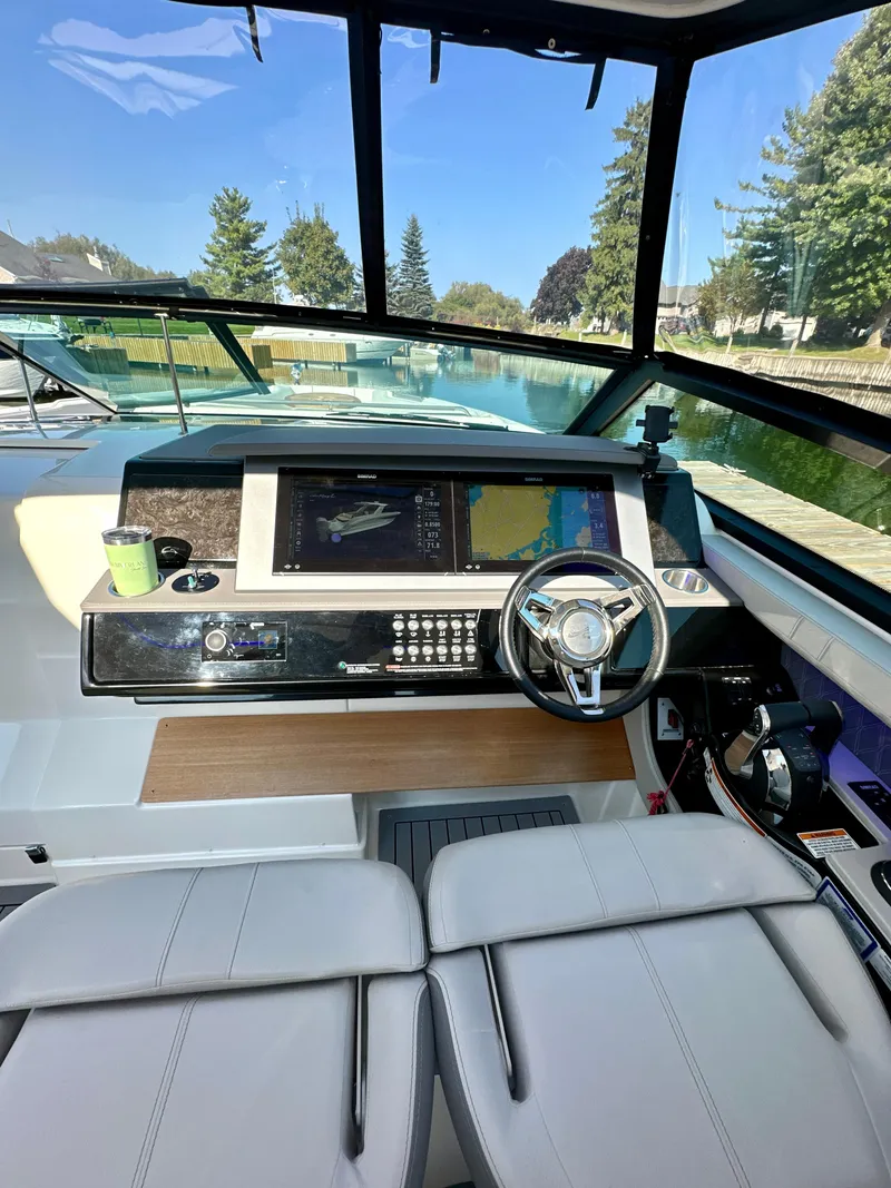 Slide: The Image of 2021 Sea Ray SLX 400 Outboard helm with modern controls and panoramic view. - 9