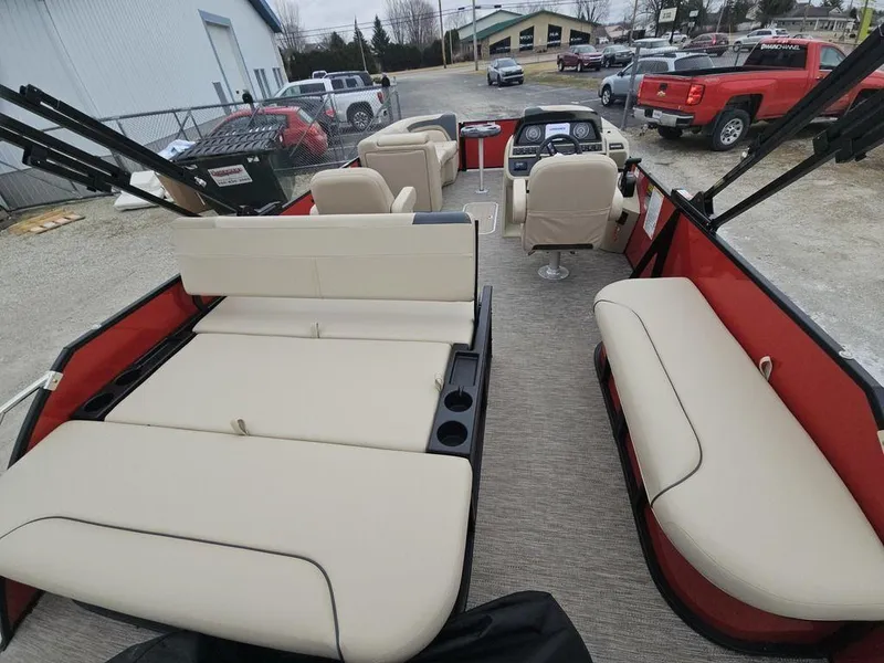 Slide: The Image of Interior of 2025 Godfrey Sweetwater 2286 SFL pontoon boat with beige seating and red accents. - 12