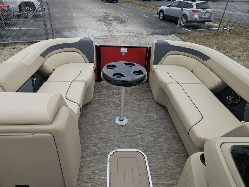 Slide: The Image of Interior of 2025 Godfrey Sweetwater 2286 SFL pontoon boat with beige seating and table. - 5
