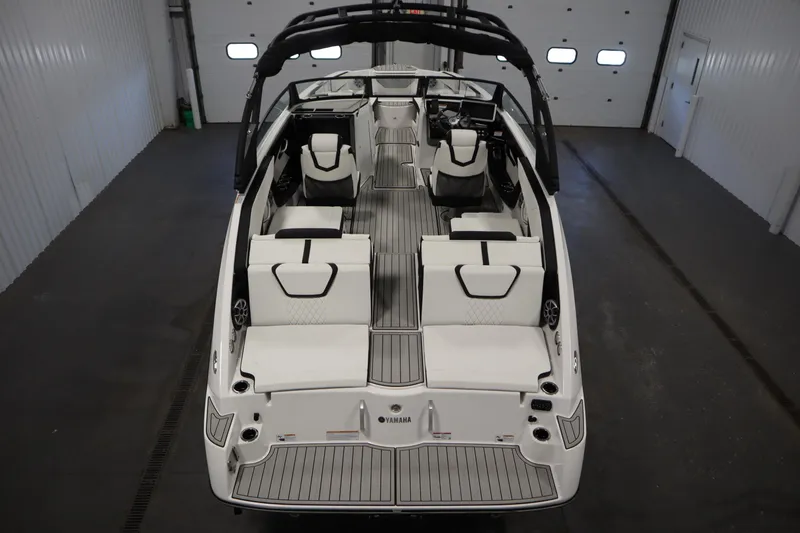 Slide: The Image of 2025 Yamaha Boats 222 SE interior, showcasing sleek seating and modern design in a spacious layout. - 2