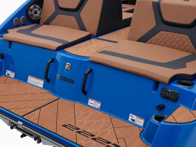 Slide: The Image of 2025 Yamaha Boats 222 XD, blue exterior, tan seating, modern design, rear view. - 4
