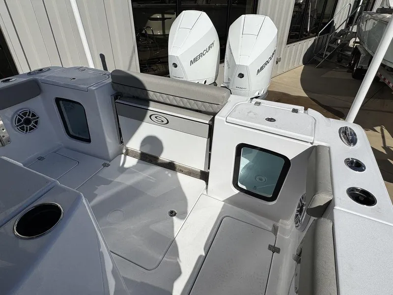 Slide: The Image of 2025 Sportsman Open 282 boat interior with Mercury engines, featuring seating and storage areas. - 10