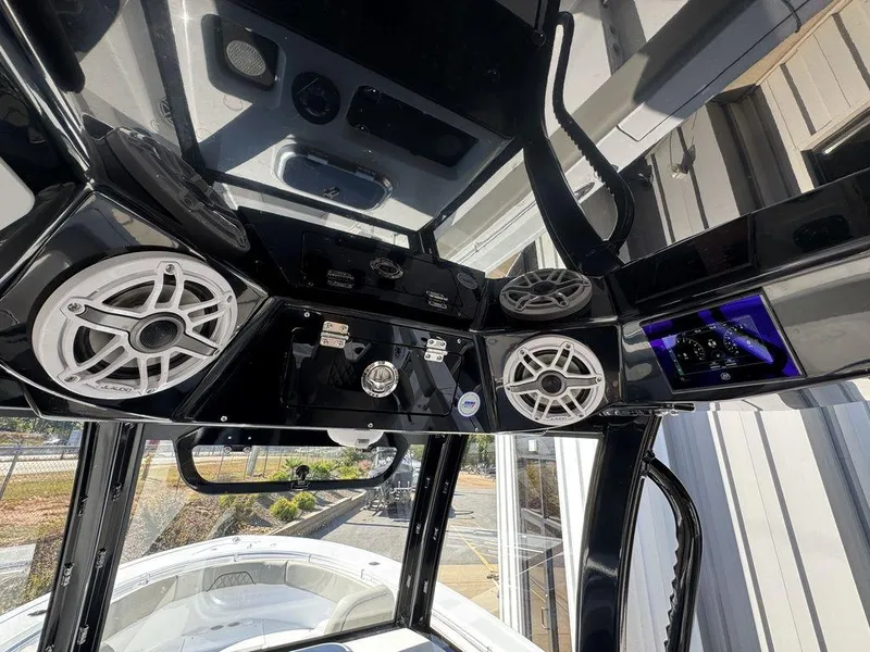Slide: The Image of 2025 Sportsman Open 282 boat interior with advanced audio system and sleek design. - 13