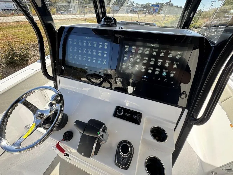Slide: The Image of 2025 Sportsman Open 282 boat dashboard with advanced controls and dual displays. - 14