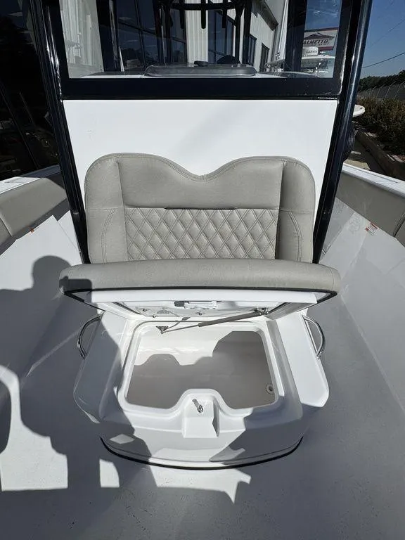 Slide: The Image of 2025 Sportsman Open 282 boat seat with storage compartment open. - 16