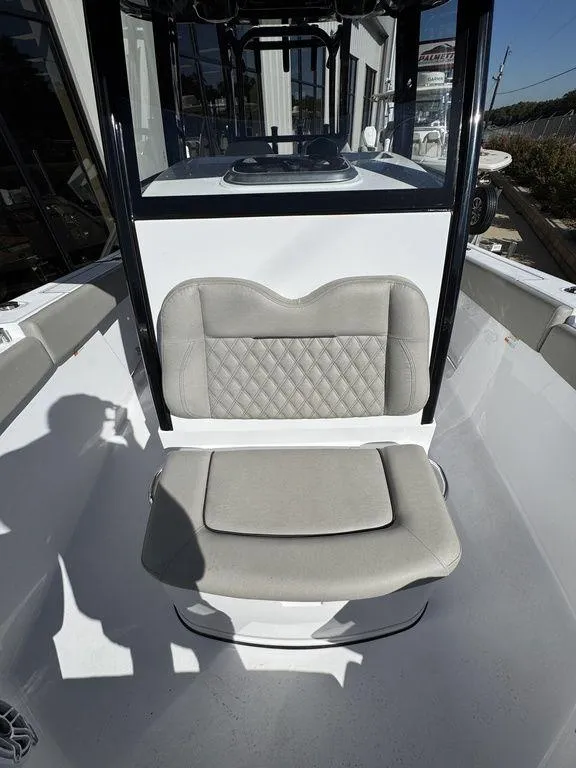 Slide: The Image of 2025 Sportsman Open 282 boat with cushioned seating and sleek design. - 17