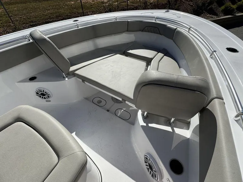 Slide: The Image of 2025 Sportsman Open 282 boat interior with cushioned seating and speakers. - 19