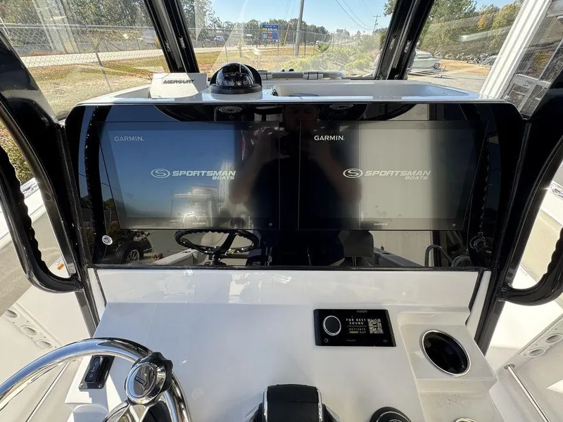 Slide: The Image of 2025 Sportsman Open 282 boat dashboard with dual Garmin displays and steering wheel. - 20