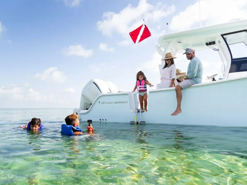 Slide: The Image of Family enjoying water activities near 2025 Sportsman Open 282 boat. - 24