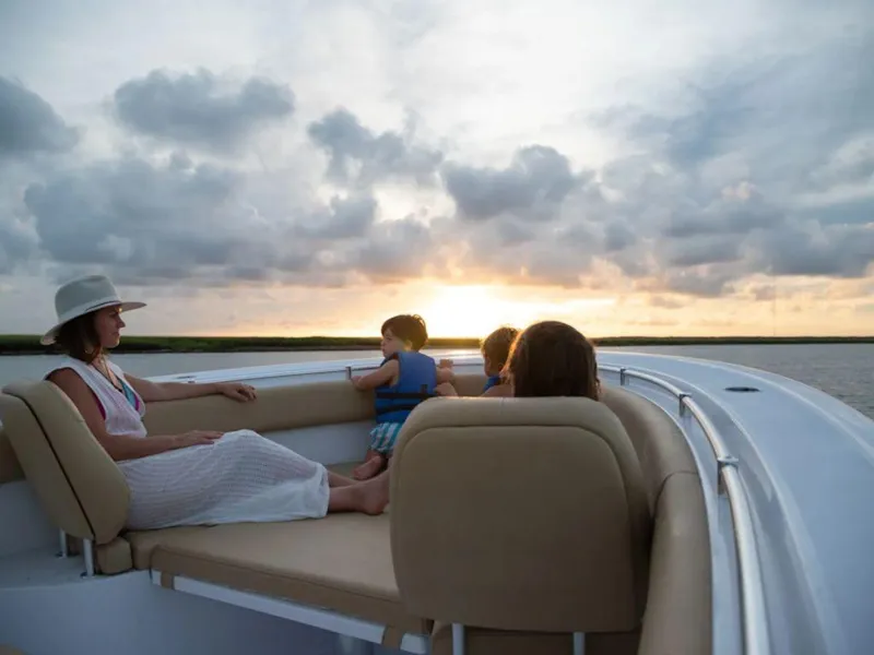 Slide: The Image of Family enjoying sunset on 2025 Sportsman Open 282 boat. - 25