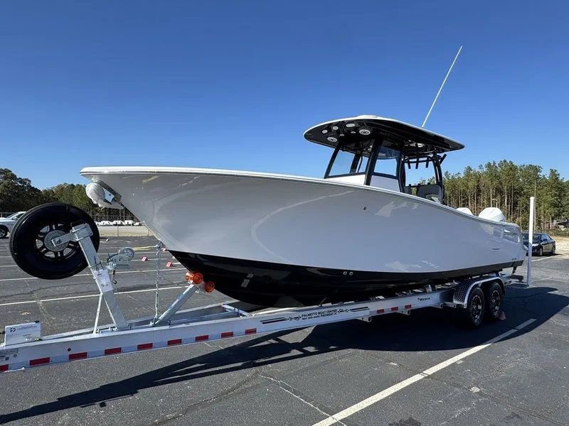 Slide: The Image of 2025 Sportsman Open 282 boat on trailer in parking lot, clear sky background. - 4