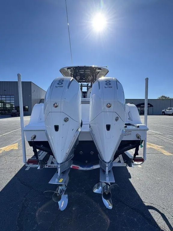 Slide: The Image of 2025 Sportsman Open 282 boat with dual outboard engines under a clear sky. - 7