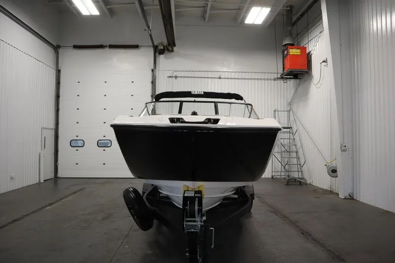 Slide: The Image of 2025 Yamaha Boats 250 SX in a garage, front view. - 1