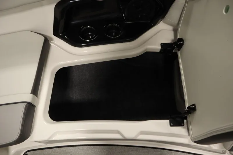 Slide: The Image of 2025 Yamaha Boats 250 SX interior storage compartment with open hatch. - 15