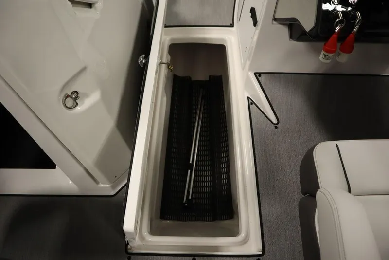 Slide: The Image of 2025 Yamaha Boats 250 SX storage compartment with interior view. - 18