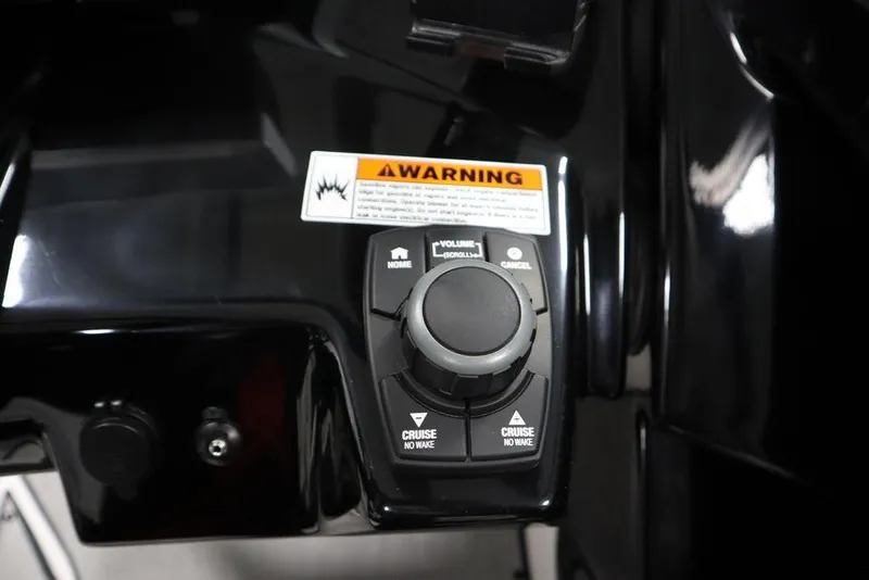 Slide: The Image of Close-up of 2025 Yamaha Boats 250 SX control panel with warning label. - 26
