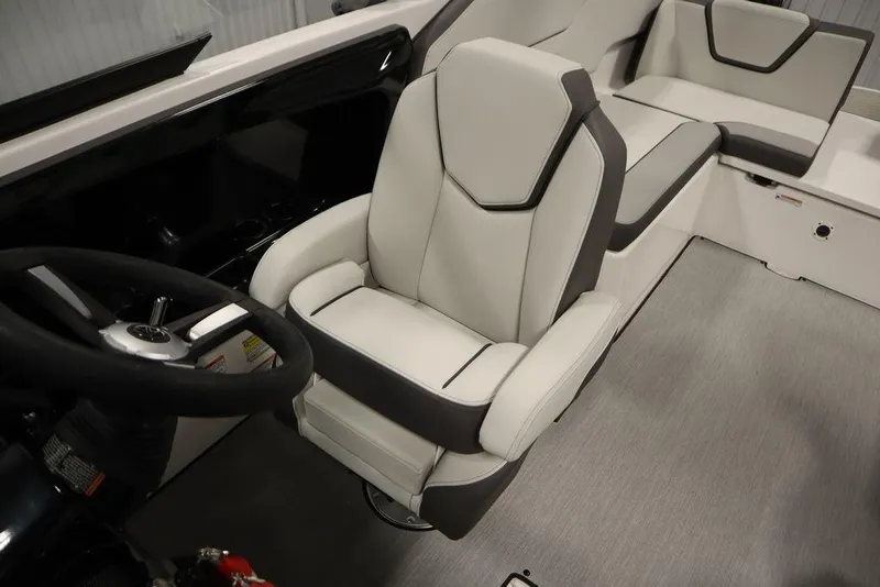 Slide: The Image of 2025 Yamaha Boats 250 SX interior with sleek seating and modern steering wheel. - 29