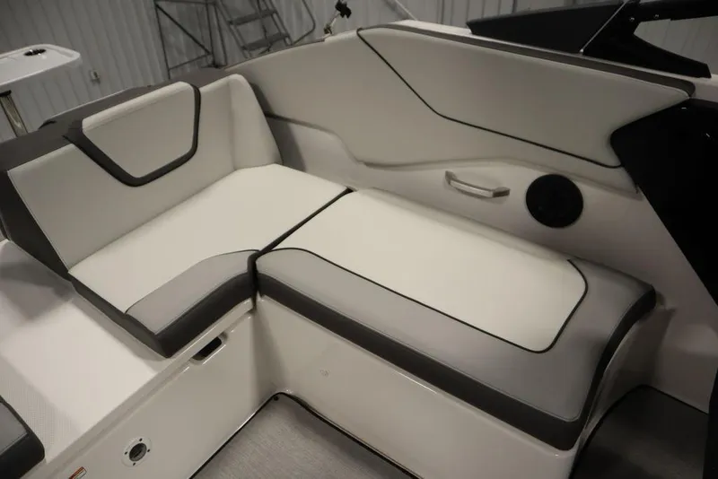 Slide: The Image of 2025 Yamaha Boats 250 SX interior seating, featuring sleek white and gray upholstery. - 37