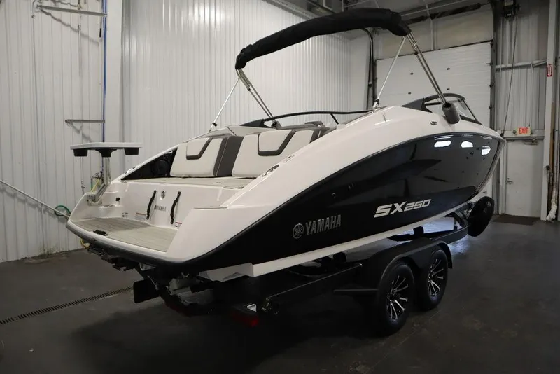 Slide: The Image of 2025 Yamaha Boats 250 SX in a showroom, featuring sleek design and modern amenities. - 4