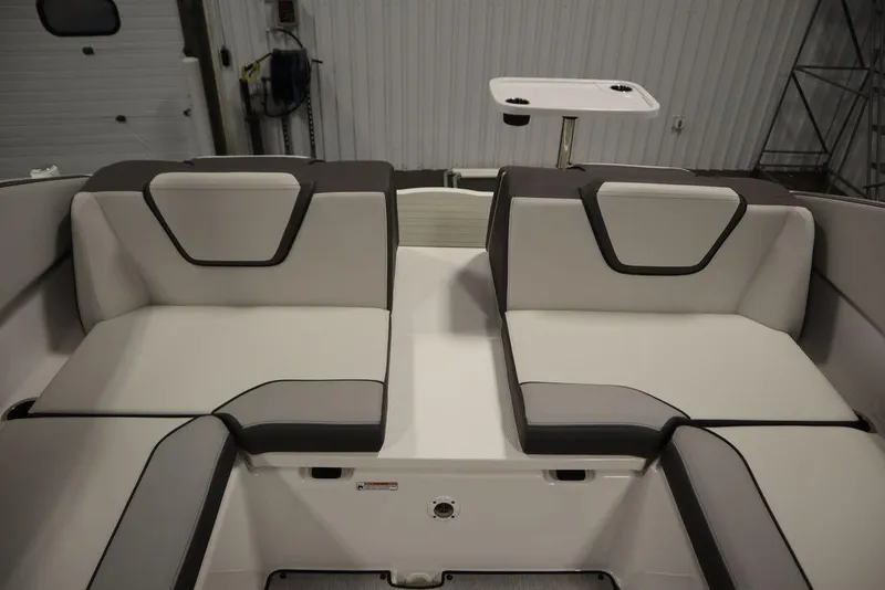 Slide: The Image of 2025 Yamaha Boats 250 SX interior seating with modern design and table. - 41