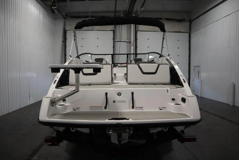 Slide: The Image of 2025 Yamaha Boats 250 SX in a showroom, rear view. - 5