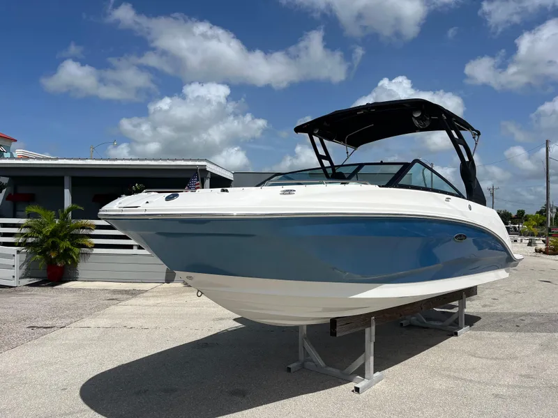 The Image of 2021 Sea Ray SDX 250 Outboard boat displayed outdoors under a blue sky. - 0