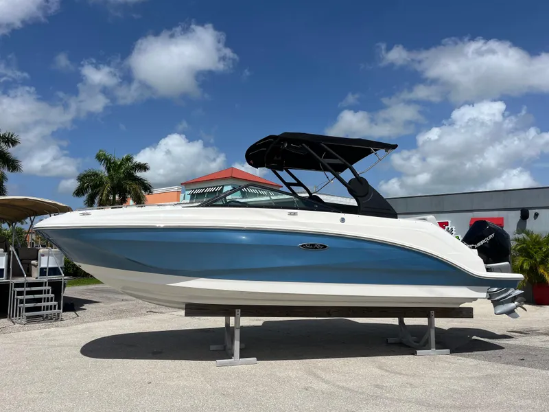 Slide: The Image of 2021 Sea Ray SDX 250 Outboard boat displayed outdoors under a clear blue sky. - 2