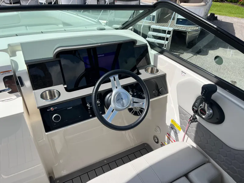 Slide: The Image of 2021 Sea Ray SDX 250 Outboard helm with modern steering and controls. - 9