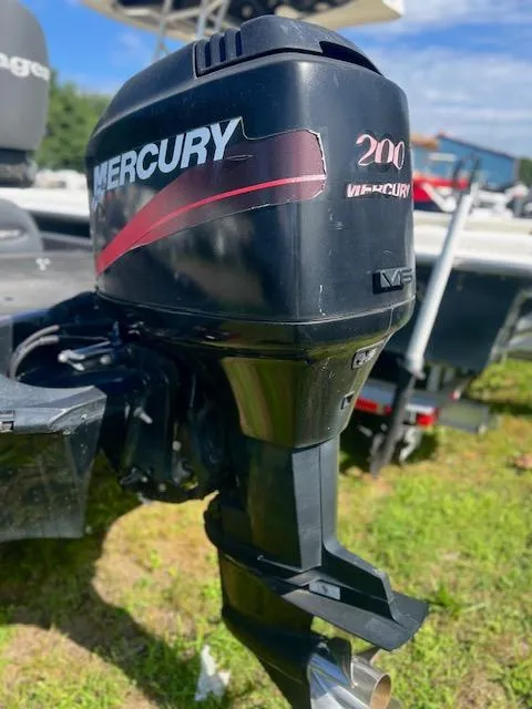 Slide: The Image of Mercury 200 outboard motor on 2003 Ranger 195VS boat, parked on grass. - 11