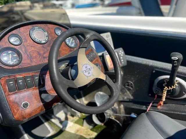 Slide: The Image of 2003 Ranger 195VS boat dashboard with steering wheel and control panel. - 8