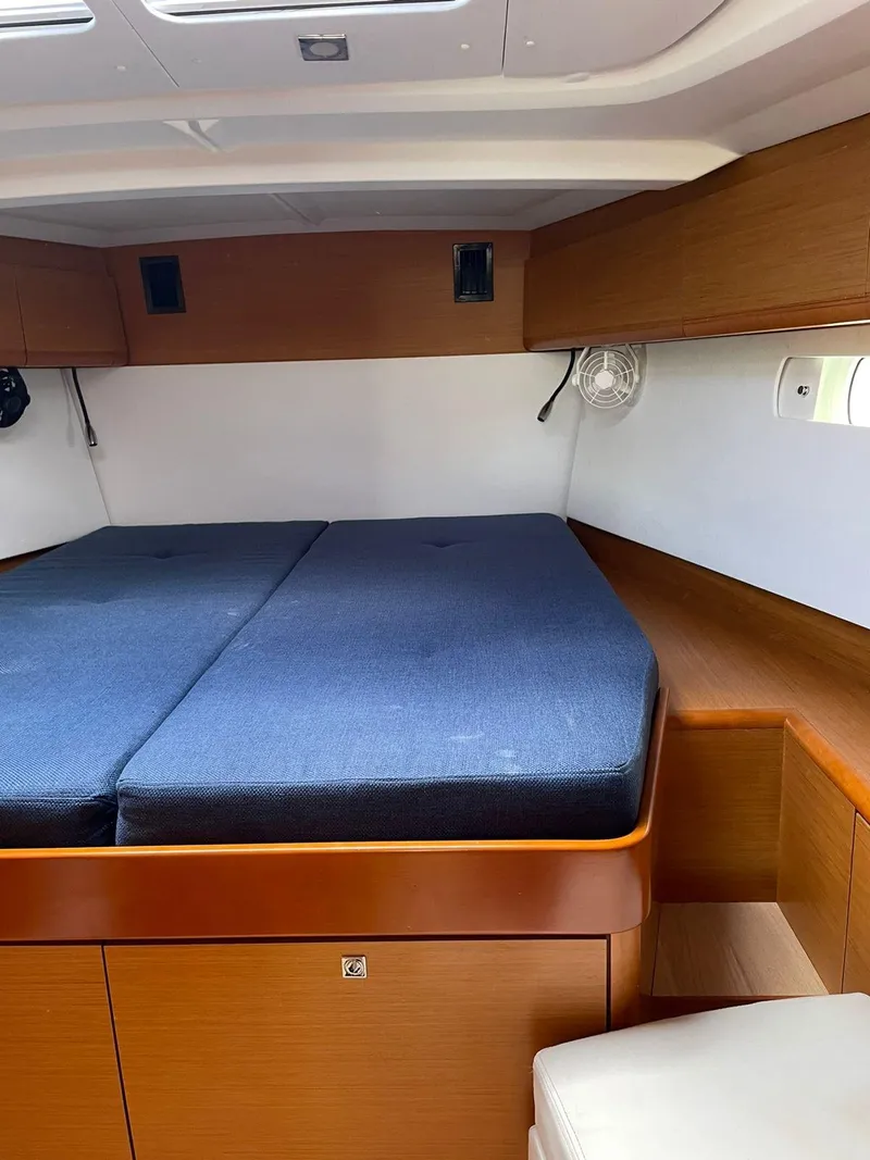Slide: The Image of Interior cabin of 2016 Jeanneau Sun Odyssey 479 with blue bedding. - 15