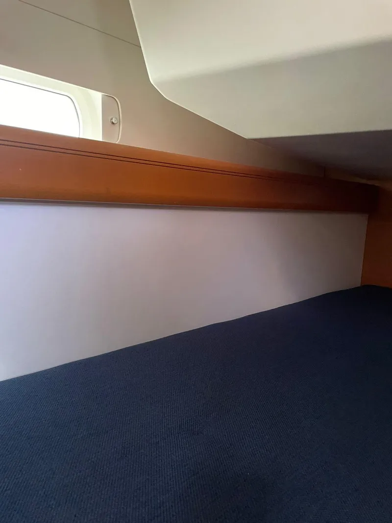 Slide: The Image of Interior cabin of 2016 Jeanneau Sun Odyssey 479 sailboat, featuring a cozy sleeping area. - 27