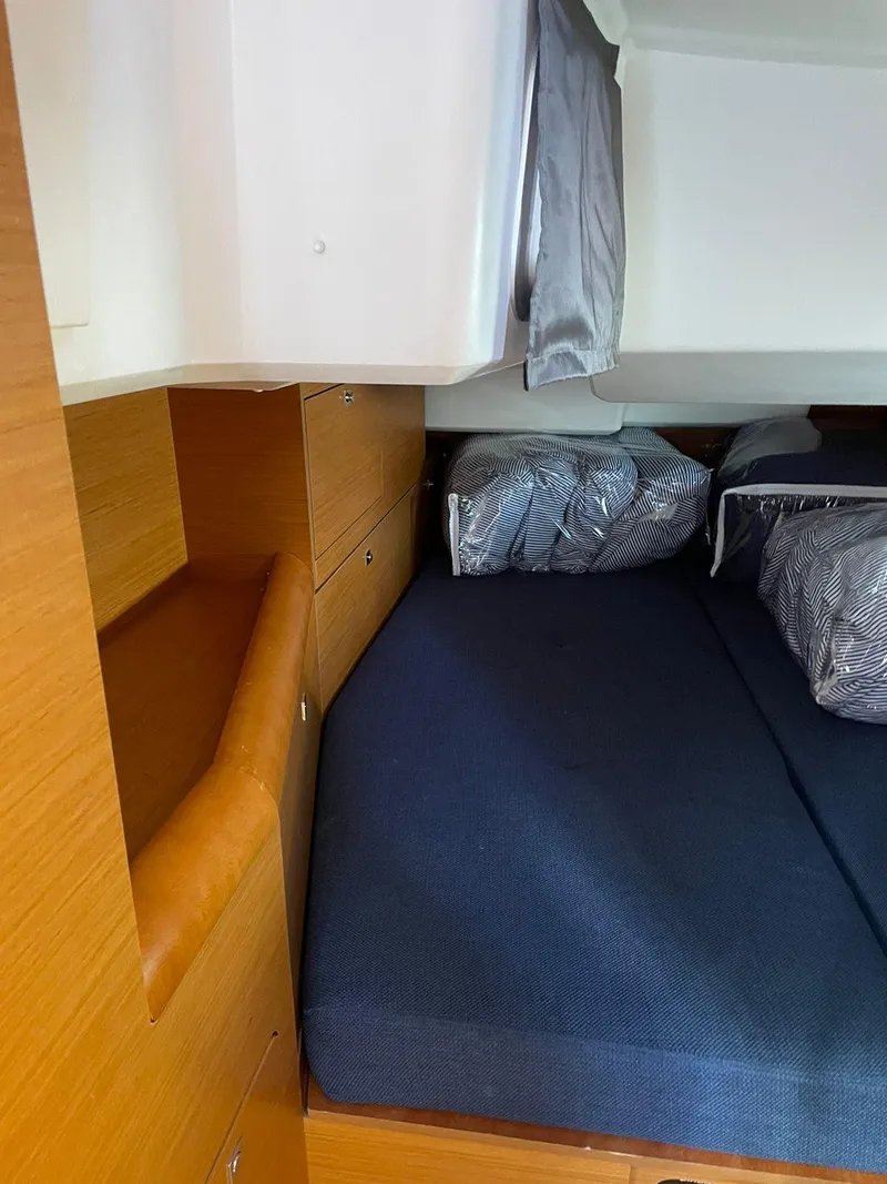 Slide: The Image of Cozy cabin interior of 2016 Jeanneau Sun Odyssey 479 sailboat with blue bedding. - 30