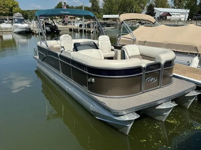Slide: The Image of 2021 Manitou RF 23 Oasis VP pontoon boat docked in a marina. - 1