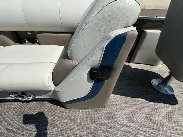 Slide: The Image of 2021 Manitou RF 23 Oasis VP boat seat with beige upholstery and blue accent. - 10