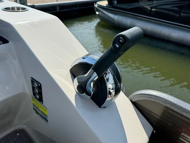 Slide: The Image of Throttle control of 2021 Manitou RF 23 Oasis VP boat by the water. - 15