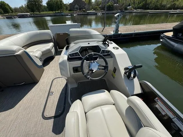 Slide: The Image of 2021 Manitou RF 23 Oasis VP pontoon boat interior with steering console and seating. - 16