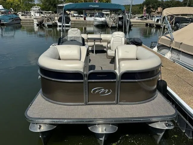 Slide: The Image of 2021 Manitou RF 23 Oasis VP pontoon boat docked at marina. - 2