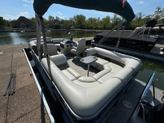 Slide: The Image of 2021 Manitou RF 23 Oasis VP pontoon boat with spacious seating at a dock. - 6