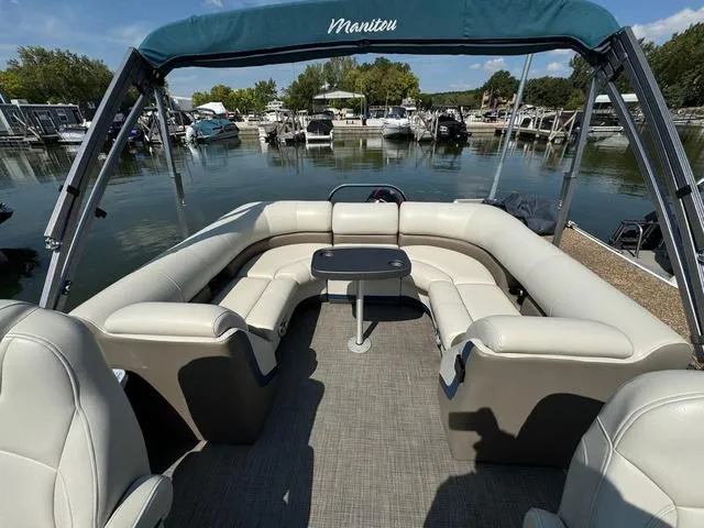 Slide: The Image of 2021 Manitou RF 23 Oasis VP pontoon boat with spacious seating at a marina. - 7