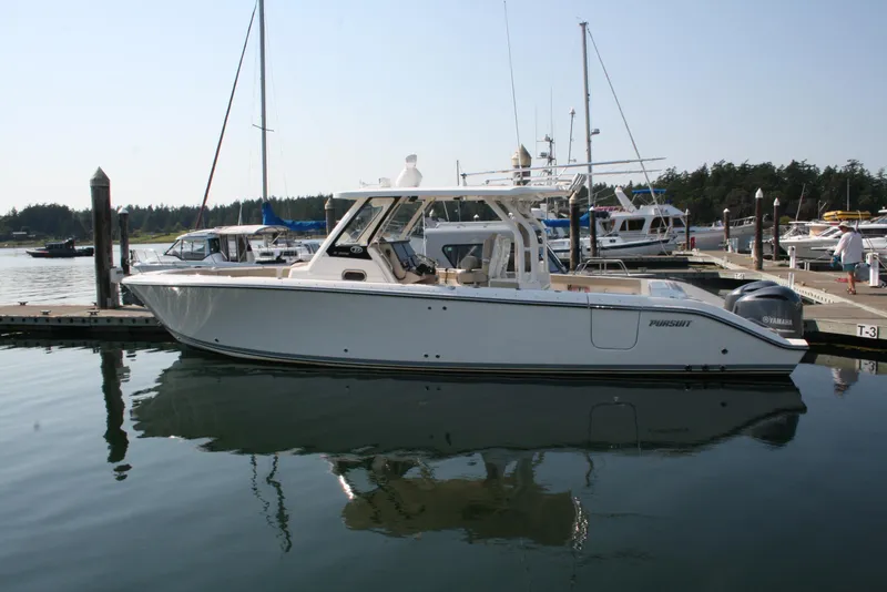 The Image of 2018 Pursuit S 328 Sport boat docked in a marina. - 0