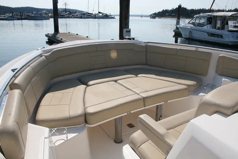 Slide: The Image of Luxurious seating on 2018 Pursuit S 328 Sport boat docked at marina. - 17