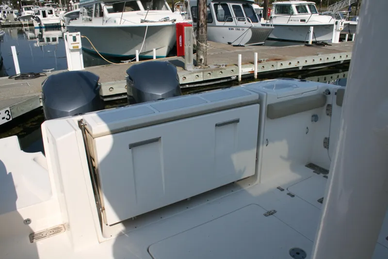 Slide: The Image of 2018 Pursuit S 328 Sport boat docked with dual engines. - 4