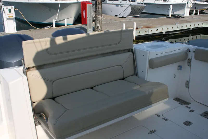 Slide: The Image of 2018 Pursuit S 328 Sport boat with beige seating at a marina. - 5