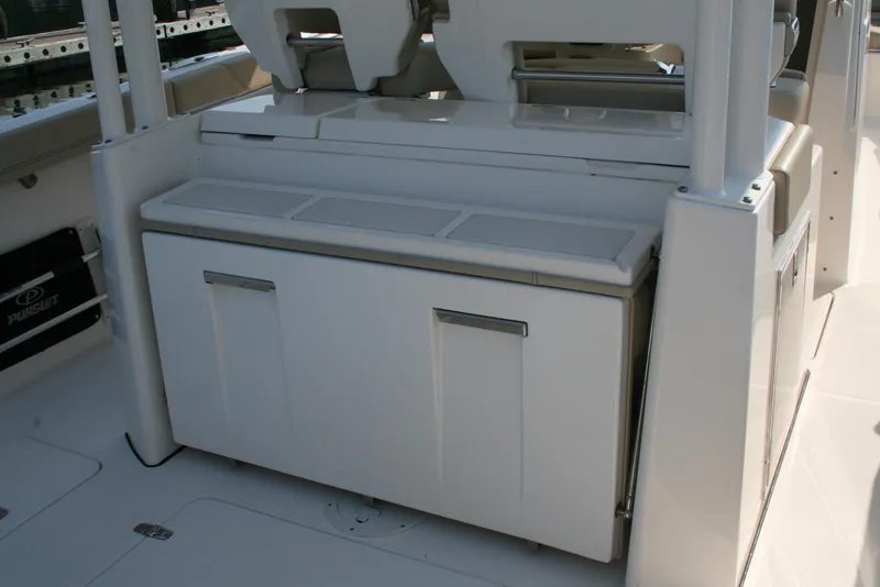 Slide: The Image of 2018 Pursuit S 328 Sport boat interior with storage compartment. - 6